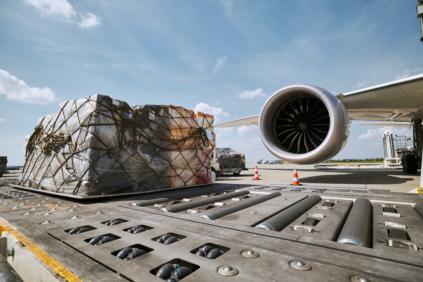 Air cargo being loaded beside a freight aircraft