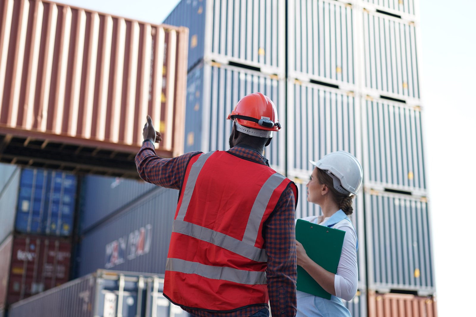Customs and logistics staff inspecting a container yard
